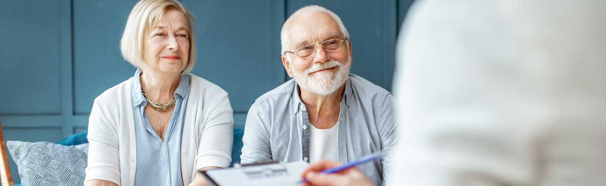 mature couple sitting down wiht an advisor