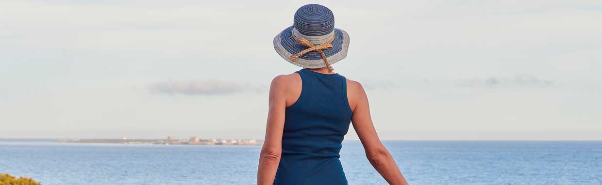 a woman looking at the ocean