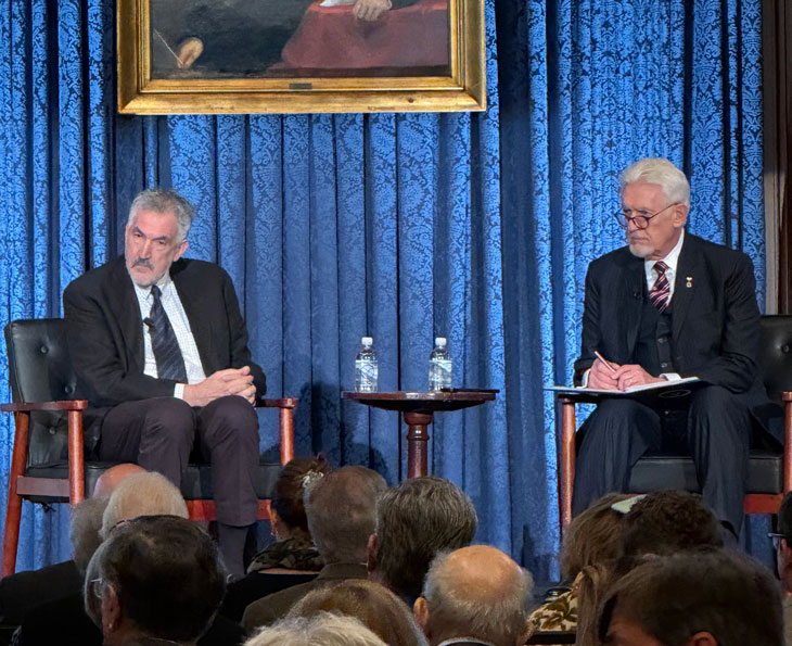 two speakers on a stage with audiance
